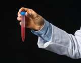 Closeup on hand of medical doctor with test tube with blood isol