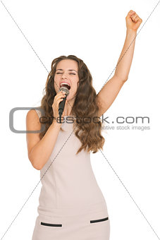 Happy young woman singing with microphone