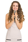 Portrait of smiling young woman with microphone