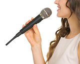 Closeup on young woman with microphone