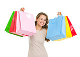 Portrait of happy young woman holding shopping bags