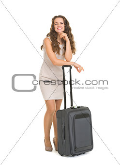 Full length portrait of happy young woman leaning on wheels suit