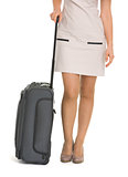 Closeup on wheels suitcase near legs woman