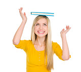 Happy student girl balancing book on head