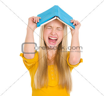 Stressed student girl with book