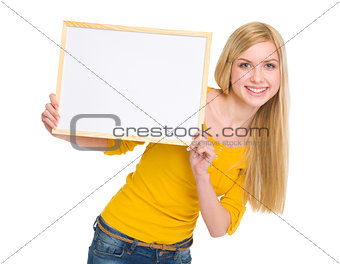 Happy student girl showing blank board