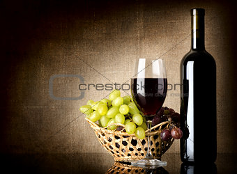 Grapes and a bottle with wine