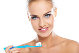 Closeup of beautiful young lady holding toothbrush