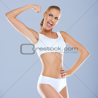 Portrait of young woman in white sportsbra smiling