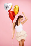 Dancing brunette with balloons