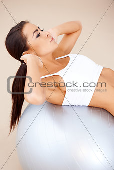 Woman doing fitness exercises with fit ball