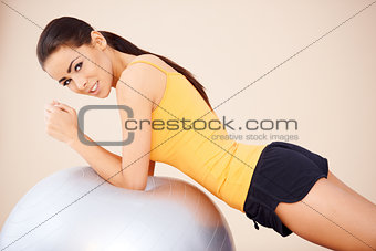 Young happy woman with fitness ball