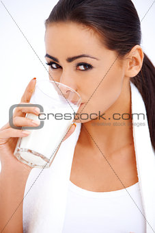 Woman is drinking milk from a glass