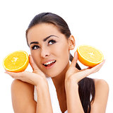 Woman with fresh orange halfs in her hands