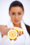 Close up of a woman showing fresh lemon