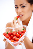 Woman holding heart shaped box of strawberries