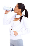 Sporty woman drinks from fitness bottle