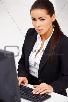 Business woman sitting in front of computer monitor