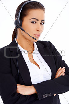 Business woman standing with arms crossed, wearing headset