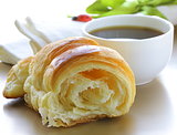 delicious breakfast of fresh puff croissant and cup of coffee