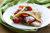 dessert crepes with strawberries and powdered sugar