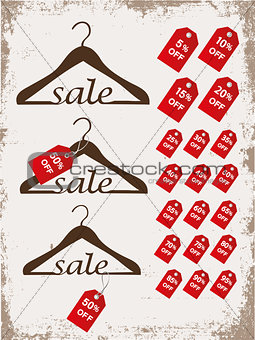 Set of hangers with tags and word sale on grunge background