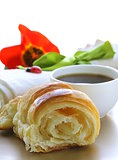 delicious breakfast of fresh puff croissant and cup of coffee