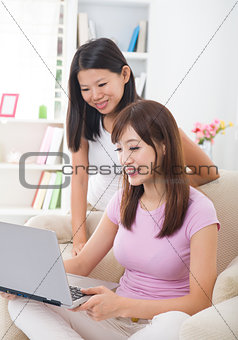chinese female friends having a good time in living room