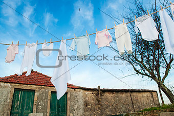 baby clothes on line outside in rural garden