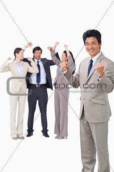 Successful businessman with cheering team