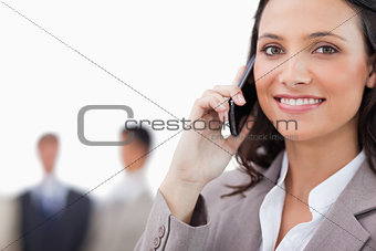 Smiling saleswoman talking on the phone