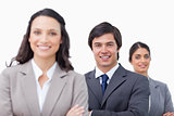 Smiling young businesspeople with arms folded