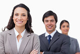 Smiling businesspeople standing with arms folded