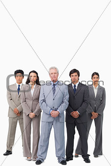 Mature salesman standing together with his team