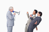 Senior businessman with megaphone yelling at his employees