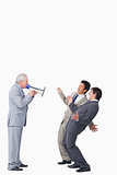 Mature businessman with megaphone yelling at his employees