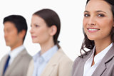 Smiling businesswoman standing next to colleagues