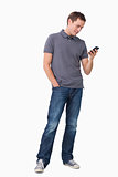 Young man typing text message on his cellphone