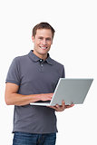 Smiling young man with his laptop