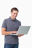 Smiling young man working on laptop