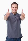 Smiling young male giving thumbs up