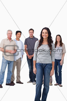 Smiling woman standing with friends behind her