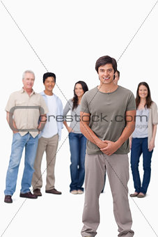 Smiling young man with friends behind him