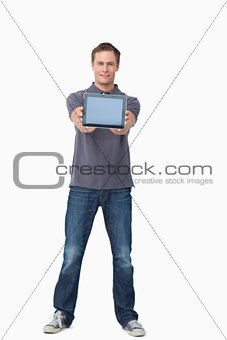 Young man showing screen of his tablet computer