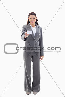 Smiling businesswoman showing a card