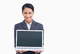 Close up of smiling saleswoman presenting laptop screen