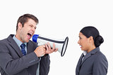 Close up of salesman with megaphone yelling at colleague