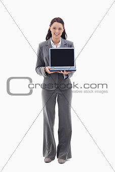 Businesswoman smiling while showing a laptop screen