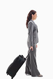 Profile of a businesswoman with a suitcase