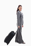 Profile of a businesswoman smiling with a suitcase